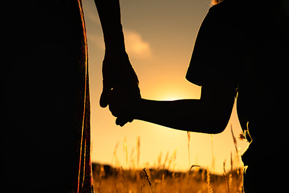 Parent holding child hand silhouette