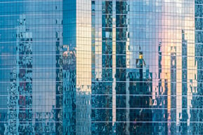 Office windows reflecting sky