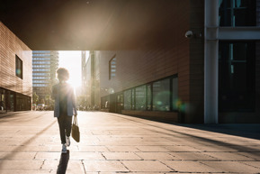 woman walking against sun