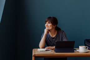 woman looking out window at desk